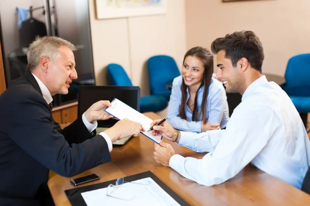 Clients discussing certified and notarized translation services with a consultant